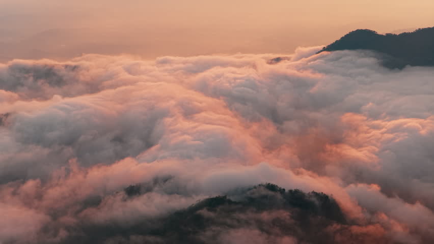 Aerial view above the sea of ​​clouds with the sunset