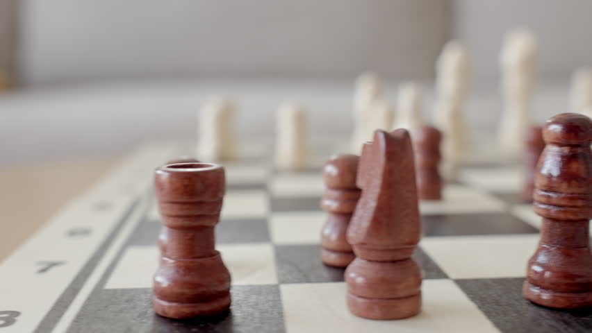Close up of wooden chess pieces on chessboard during game. Concept of strategy, logic, planning and intellectual board game