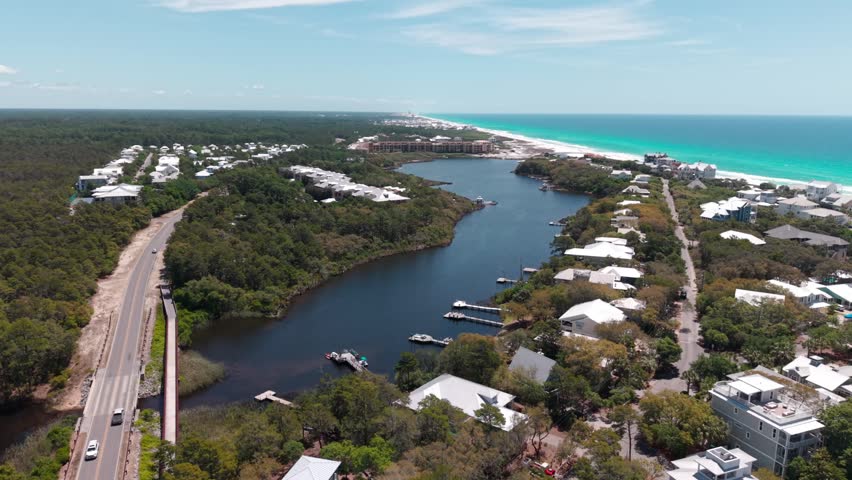 Drone orbit at coastal Big Redfish Lake residential luxury real estates with docks near 30A highway road, Santa Rosa Beach, Florida, USA