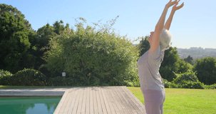 Mature women practicing yoga following senior woman leading, lunging and folding on mats by pool. Outdoor, deck, trio, wellness, fitness, stretch, calm - Powered by Shutterstock - Get 15% off with code: PIKWIZARD15