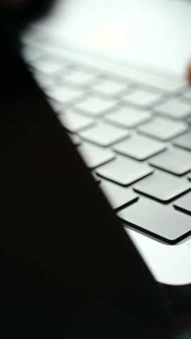 Extreme close up person hands and fingers typing on modern laptop keyboard, representing concepts like working, writing, programming, online communication. Man fingers typing on laptop keyboard.