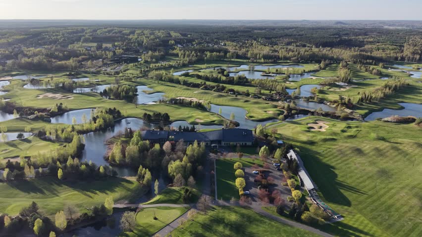 Sunny summer day over golf course and forest	
