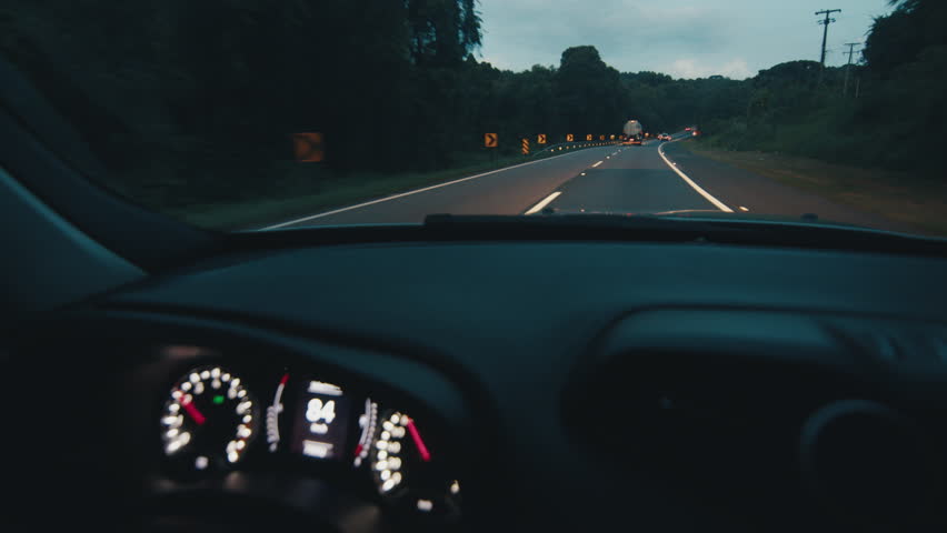 Man steers the car at night on the speedway