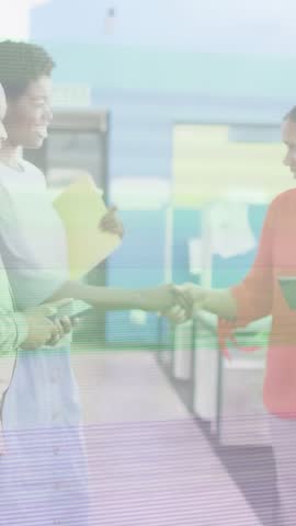 Vertical video: Team shaking hands then checking phone for meeting, scanlines crossing subjects. Office, collaboration, cubicles, tablet, smartphone, folder, vertical video