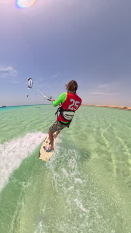 extreme kitesurfer performing dangerous stunt lifted high by boat releasing rope midair landing on turquoise sea continuing fast ride freedom adventure adrenaline water sport lifestyle summer outdoors
