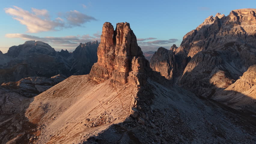Aerial view of golden sunset shines over Dolomites mountain peak in Tre Cime di Lavaredo during autumn at South Tyrol, Italy