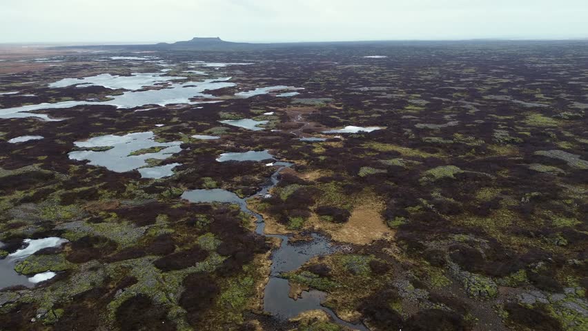 Drone view of lava fields with green moss and ice in Iceland. Unique volcanic landscape showing contrast of fire and ice in remote nature.