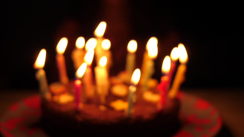 Happy birthday cake child girl blow out candles in slow motion