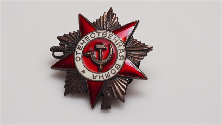 Soviet Order of Patriotic War medal sliding into frame on white