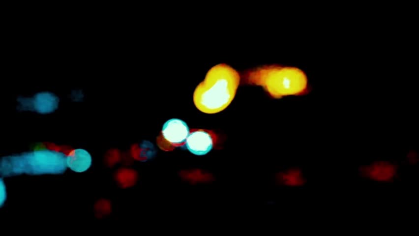 Luminous blurry lights of city cars at night time.