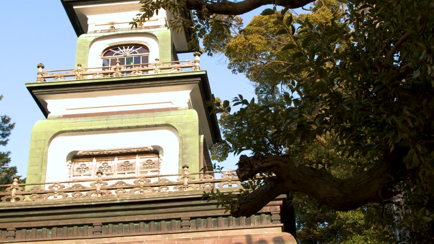 Low angle shot of the historic Oyama Shrine gate under bright daylight in Kanazawa