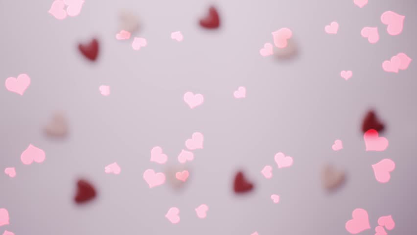 A romantic animation featuring a hand holding a heart-shaped frame, with the phrase “be my valentine” written inside, while multiple red hearts float upward in a loop.