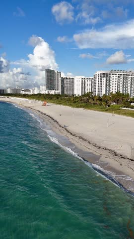 Aerial view of Miami Beach coastline with turquoise Atlantic water, sandy shore and urban waterfront, Florida USA. g.