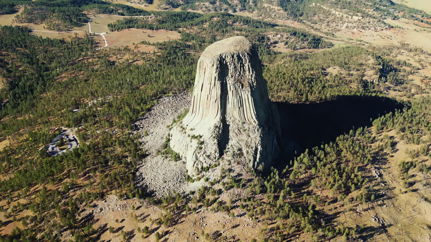 Aerial drone view of Devils Tower National Monument rising dramatically above the surrounding landscape in Wyoming, US