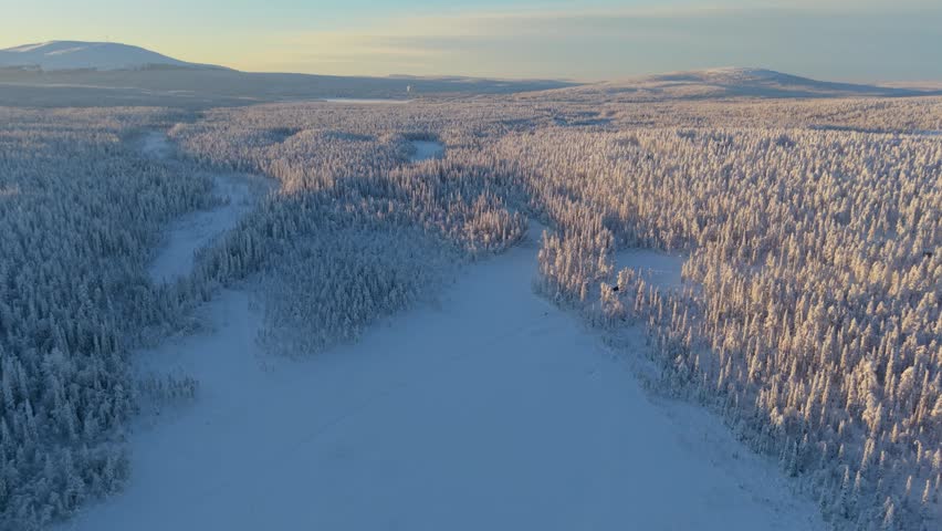 Experience the enchanting beauty of Akaslompolo, Lapland with its vast snowy forests and tranquil vistas. The winter scene captures the essence of a peaceful, frosty paradise.