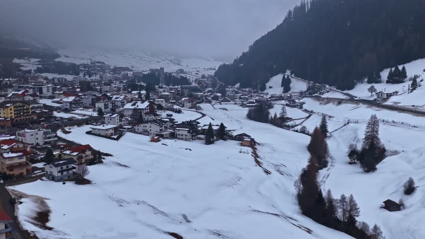 Snowy alpine village surrounded by ski slopes and conifer forest. Austria, Nauders