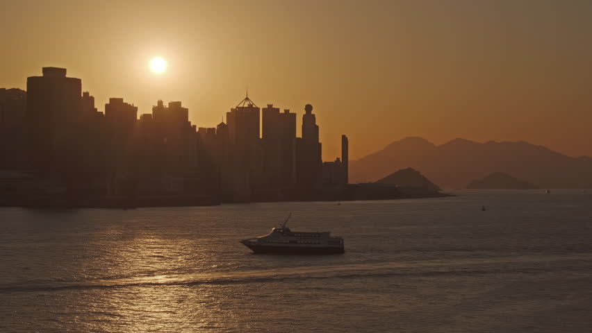Hong Kong at sunset. Boats in Victoria Harbour and Hong Kong Central, timelapse 4k