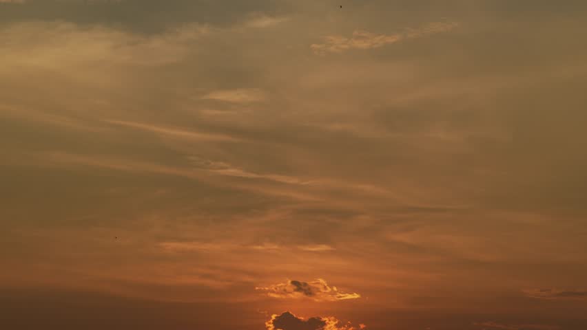 Stunning red sunrise over the horizon with dramatic orange clouds. Perfect cinematic background for morning themes, nature, and peaceful atmosphere.
