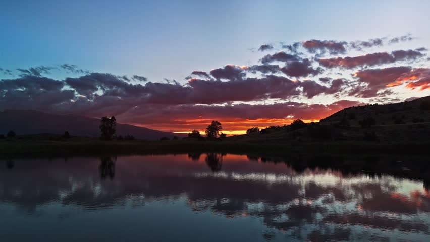 Golden sky mirrors over still water