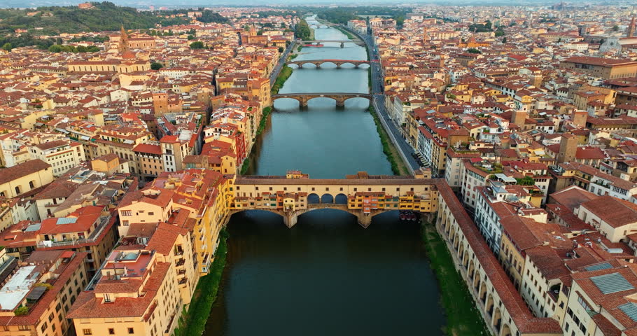 Majestic Florence Italy unique urban architecture riverside. Famous Ponte Vecchio bridge scenic Arno river landscape summer evening. Travel tourism destination exploration landscape high angle.