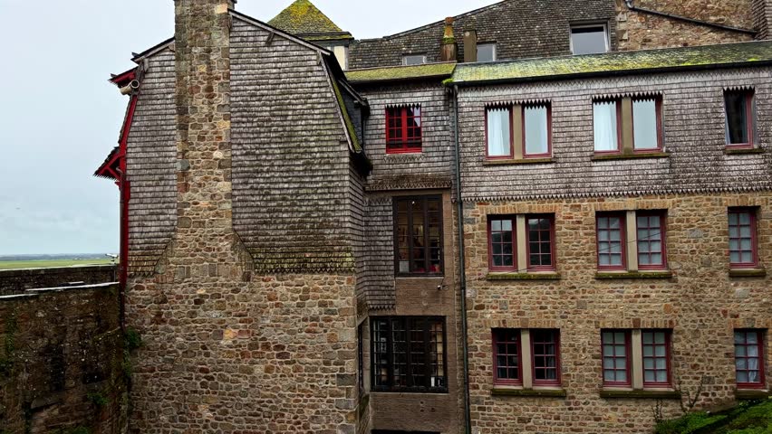 Stone buildings with red window accents in Mont-Saint-Michel