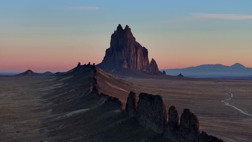 Drone view of Shiprock, a well-known Southwest landmark, surrounded by vast desert terrain and open skies, ideal for travel and destination storytelling