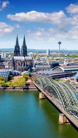 Elevated time lapse view of the cityscape of Cologne, Germany, with Cathedrale and street traffic during a sunny summer day with clouds