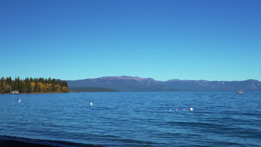 Serene Lake Tahoe Landscape With Golden Trees And Gentle Water Ripples