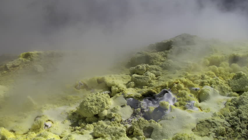 Close-up of vibrant yellow sulfur crystals on a fumarole field. Natural mineral deposits on the slopes of Vulcano Islands, Italy.
