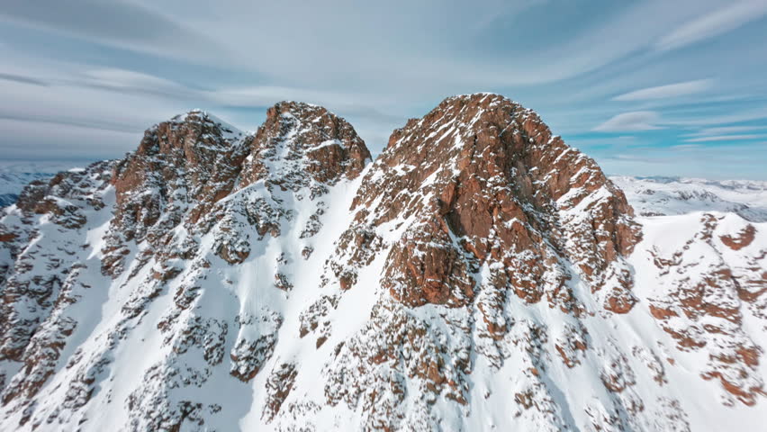 Stunning aerial view of snow-covered Swiss Alps, showcasing rugged beauty