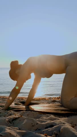 Barre workout. stretching outdoors. yoga beach. Athletic young woman is doing exercises on mat, at the beach during sunset or sunrise. Fitness training outdoors. Fitness, ballet, sport, yoga