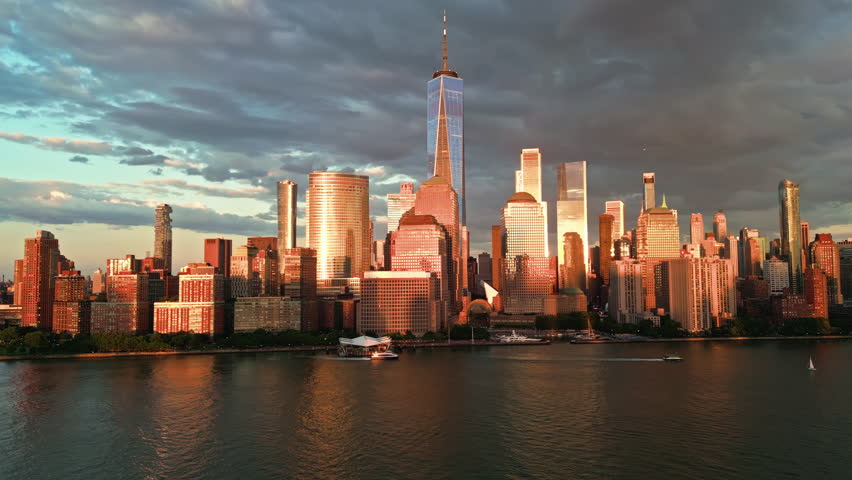 New York skyline with sunset glow. New York skyline over waterfront. Downtown Manhattan frames New York skyline. Drone view captures New York skyline.