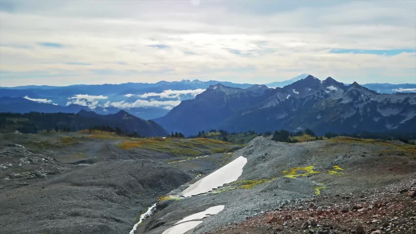 panoramic view of rugged mountain peaks in the Cascade Range, seen from Panorama Point (elevation 6,227 feet) on the Skyline Trail in Mount Rainier National Park, Washington.