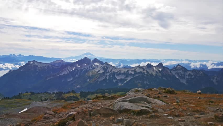 panoramic view of the rugged Tatoosh Range and distant peaks, captured from the popular Panorama Point viewpoint on the Skyline Trail in Mount Rainier National Park, Washington State.