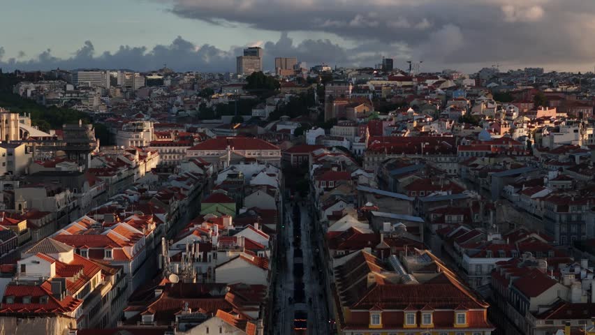 Aerial view of Praca do Comercio and the dense red rooftops of the Baixa district under a cloudy sky in Lisbon, Lisbon, Portugal.