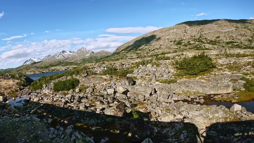 White Pass train ride between Skagway Alaska and Whitehorse Yukon Canada. Beautiful sunny day with white clouds and blue sky