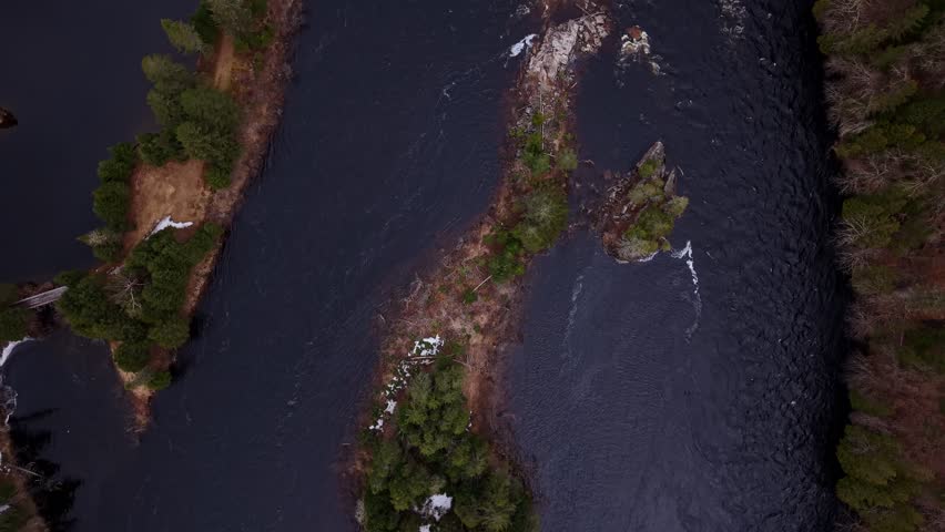 aerial river scene with evergreen forest and natural canadian terrain