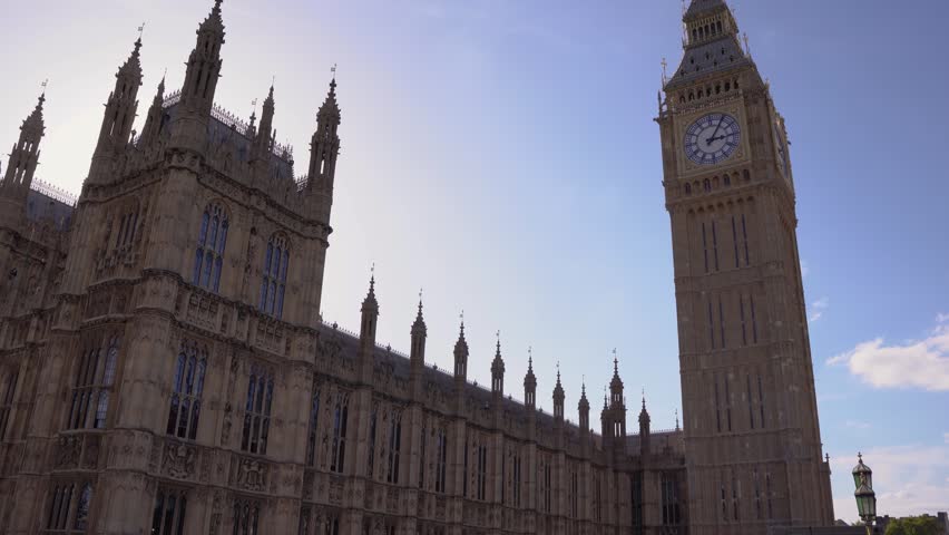 Elizabeth Tower commonly known as Big Ben and Houses of Parliament

A majestic low-angle view of the Elizabeth Tower (commonly known as Big Ben) at the Palace of Westminster in London, captured on a sunny morning. The intricate details of the clock face and the Gothic Revival architecture are set against a striking deep blue sky dotted with puffy white clouds. This iconic symbol of British democracy is a quintessential example of Victorian design and a must-see landmark for travelers visiting the UK.