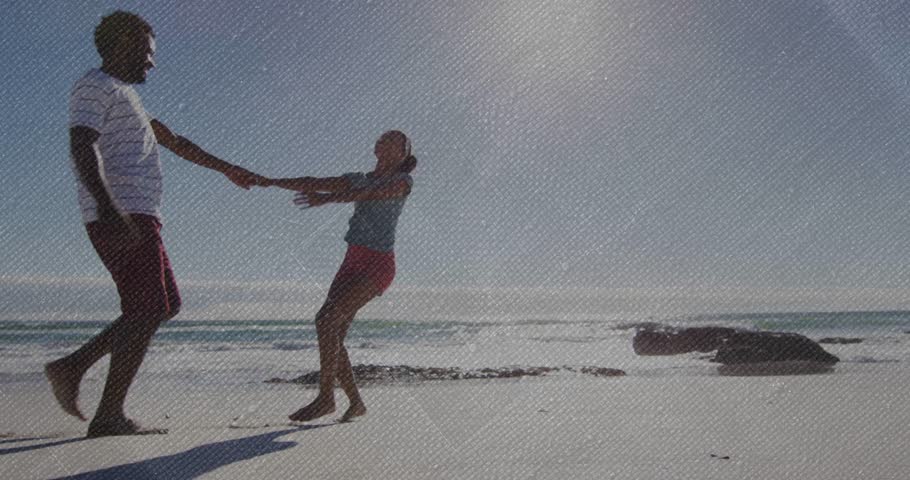 Man extending arm spinning woman moving along shore turning to face for travel with animated trails. Beach, couple, sunlit, shadows, horizon, tidepool, rocks