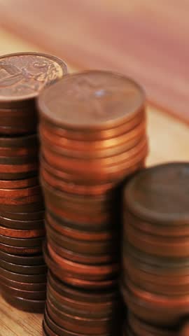 Close-up of stack of coins on table 4k
