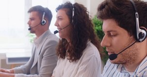 Customer support operators team with headset working in office. Serious busy call center and helpdesk agents sitting in row to explain information, technical service staff talking to clients on phone - Powered by Shutterstock - Get 15% off with code: PIKWIZARD15