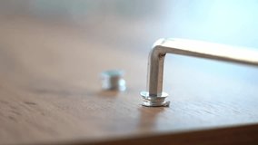installing furniture fittings with a hex key close-up. furniture assembly - Powered by Shutterstock - Get 15% off with code: PIKWIZARD15