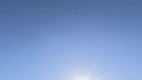 A pair of pigeon birds fly across the bright blue sky in slow motion, moving from bottom left to center, approaching each other closely, - Powered by Shutterstock - Get 15% off with code: PIKWIZARD15