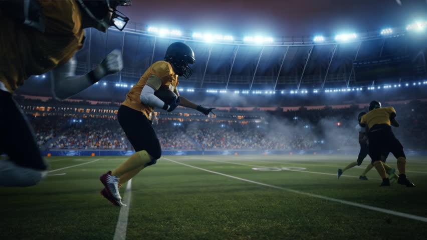 American Football Field Two Teams Compete. Players Run to Score Touchdown Points. Professional Athletes Fight for Victory. Championship Event in a Packed Arena Stadium. Cinematic Slow Motion