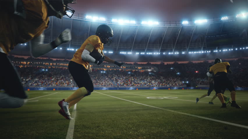 American Football Field Two Teams Compete. Players Run to Score Touchdown Points. Professional Athletes Fight for Victory. Championship Event in a Packed Arena Stadium. Cinematic Slow Motion