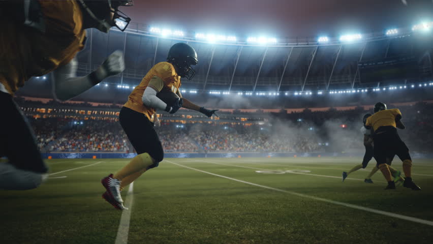 American Football Field Two Teams Compete. Players Run to Score Touchdown Points. Professional Athletes Fight for Victory. Championship Event in a Packed Arena Stadium. Cinematic Slow Motion