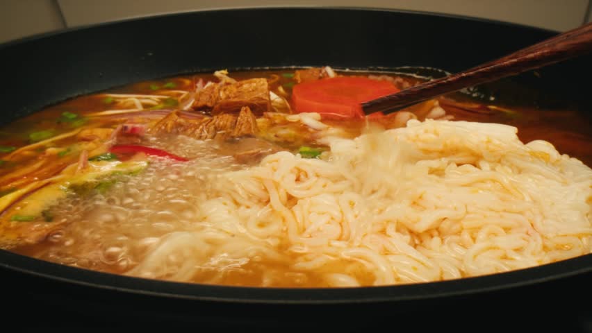 Vietnam traditional pho bo soup on delivery, Beef noodles. Pho Bo Soup with beef, rice noodles, ginger, lime, chili pepper in bowl. Vietnamese cuisine. Pho Noodle Soup restaurant Close-up.