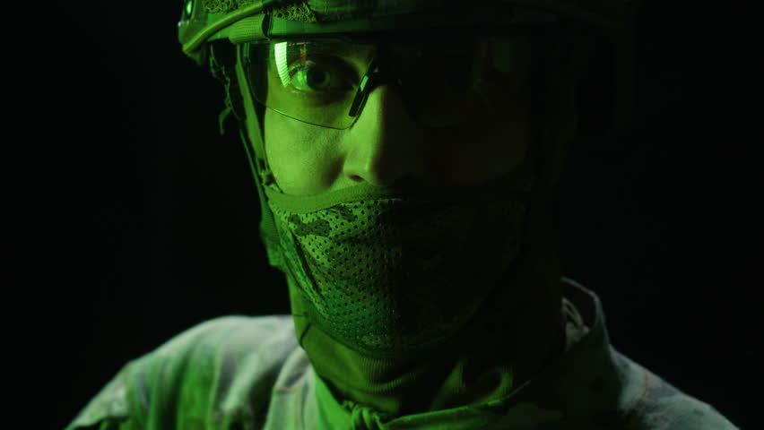 Portrait of modern soldier in military uniform and a helmet with headphones rifle, army warrior Warrior Military Gear Ready for Battle, airsoft Players in Tactical Gear and Riot Police Training