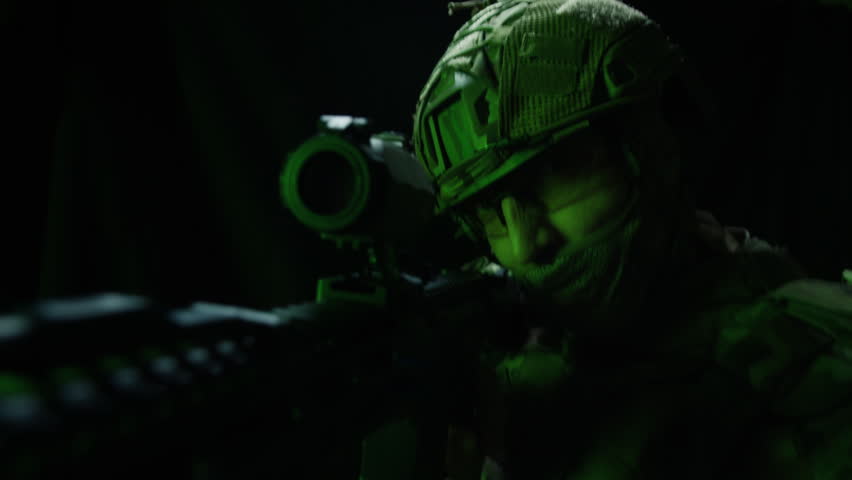 Portrait of modern soldier in military uniform and a helmet with headphones rifle, army warrior Warrior Military Gear Ready for Battle, airsoft Players in Tactical Gear and Riot Police Training