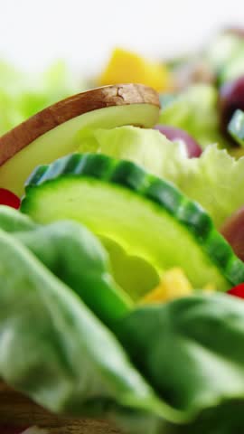 Vertical video: Cursor tap opening overlays, salad filling view while banners sliding showing likes. Cucumber, greens, olives, mushrooms, cheese, closeup, vertical video